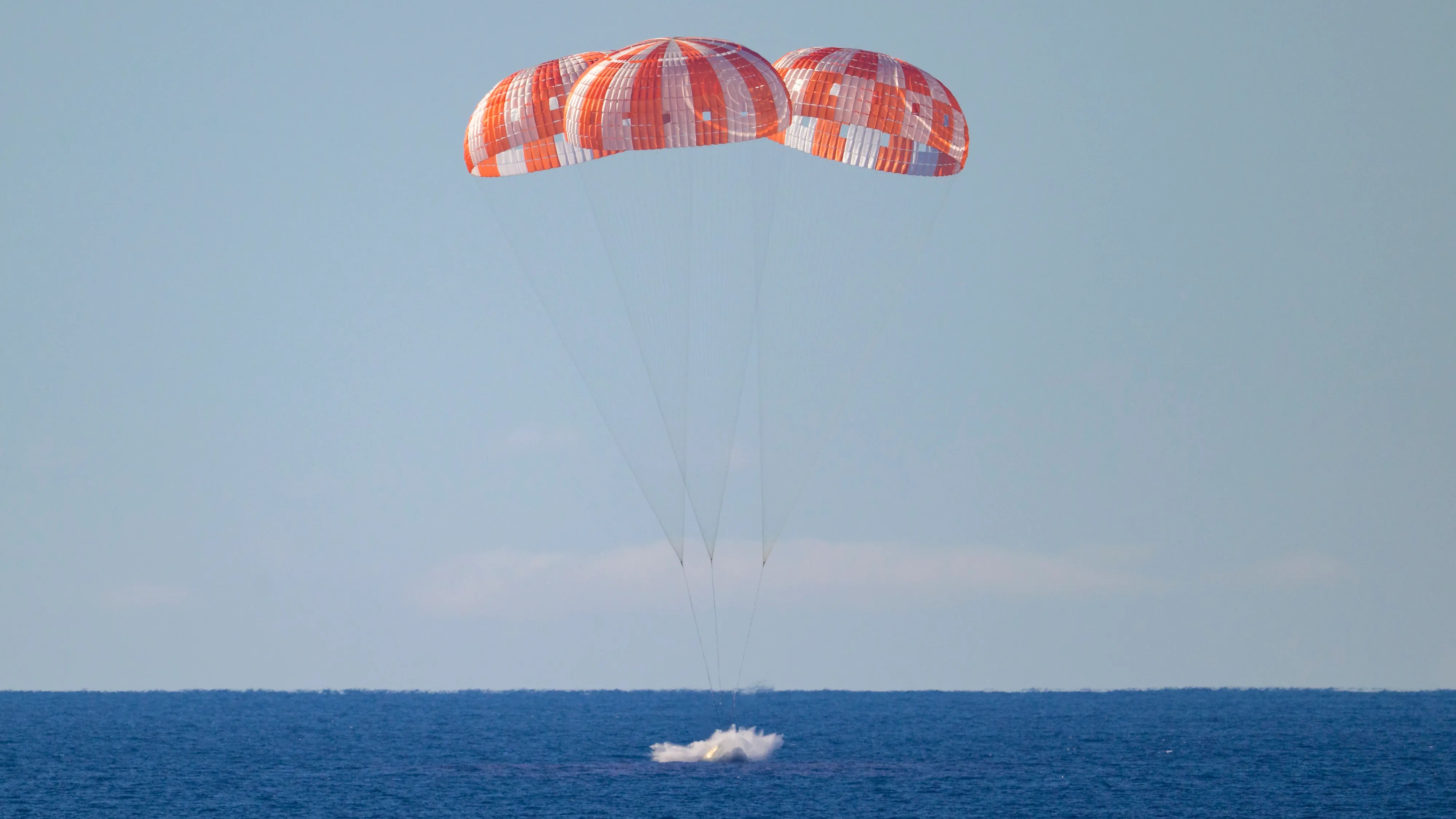 Orion splashdown — three NASA parachutes